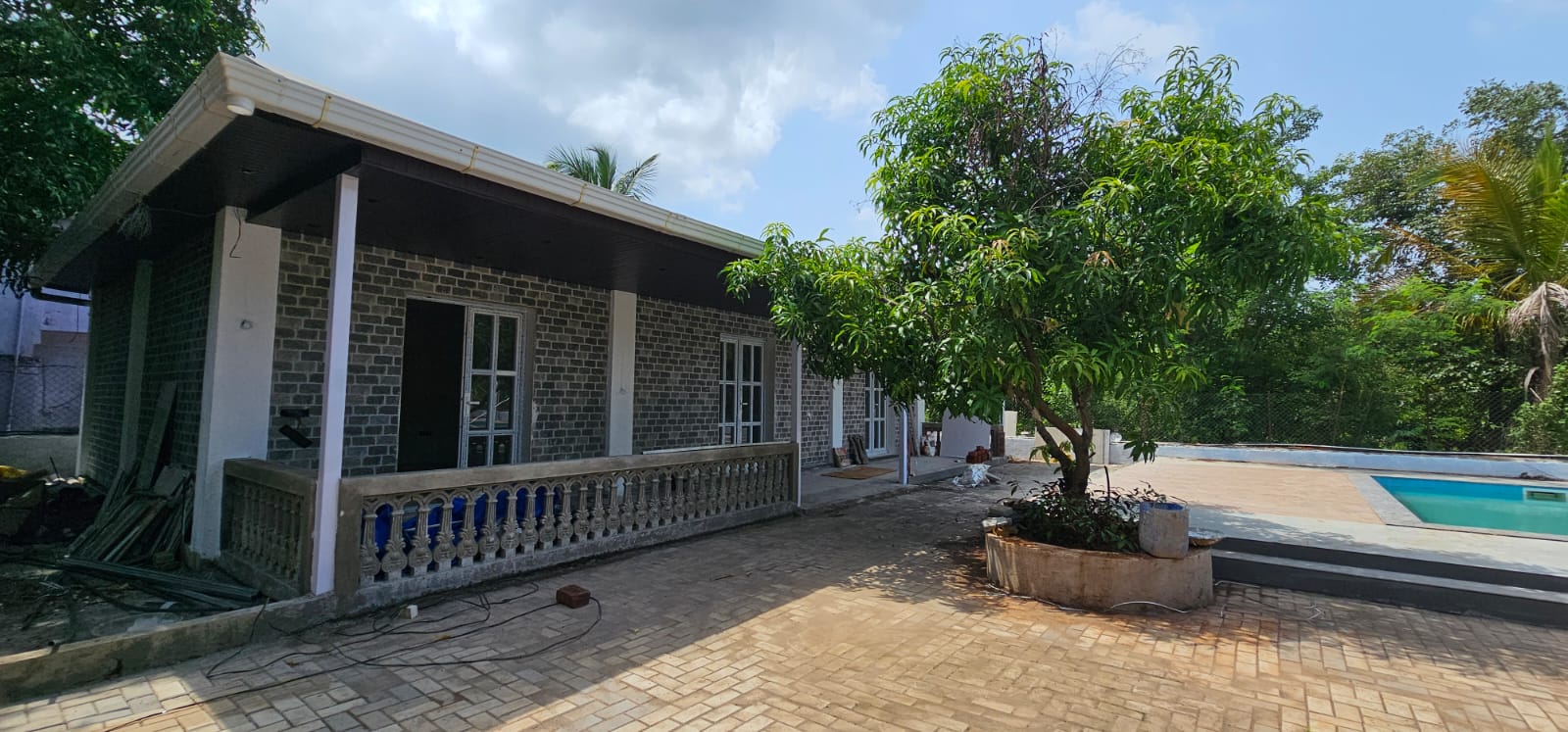 Stone villa veranda with balustrade beside the pool