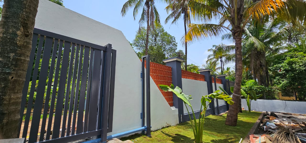 Gated private entrance lined with palms